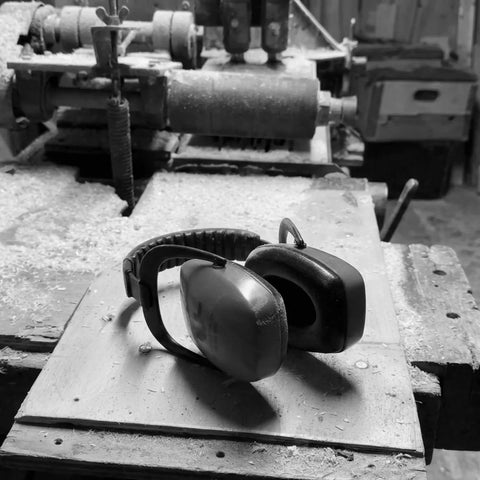 protective ear defenders paigutatud on workbench in woodturning töökoda