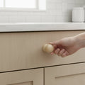 28 mm oval puidust mööblinupp installed on cabinet door